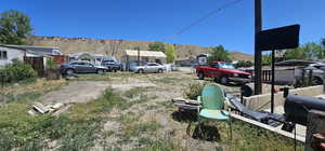 View of yard featuring a garage, a mountain view, and an outdoor structure