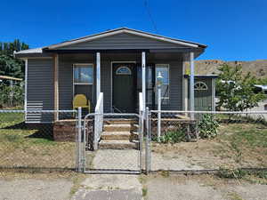 View of front of property with a mountain view and a porch