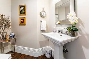 Bathroom with hardwood / wood-style flooring and toilet