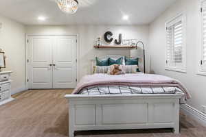 Carpeted bedroom with a closet