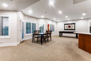 Dining area featuring light carpet