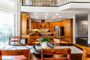 Living room with sink, a high ceiling, and light tile floors