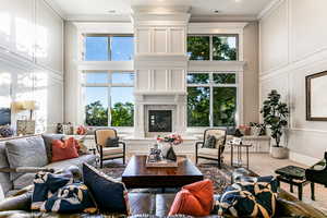 Living room with ornamental molding and a wealth of natural light