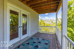 Balcony featuring french doors and a mountain view