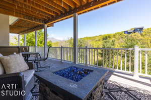 Wooden deck featuring an outdoor fire pit