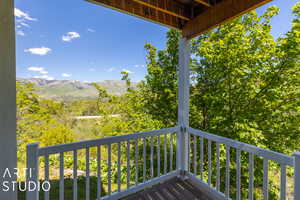 Covered Patio off of basement with a mountain view