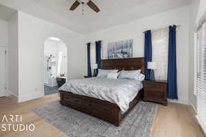 Bedroom with ceiling fan, light hardwood / wood-style floors, and ensuite bath