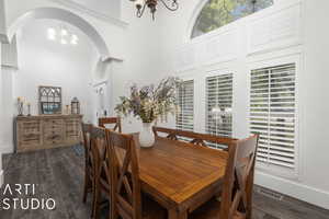 Dining area featuring dark hardwood / wood-style floors and an inviting chandelier