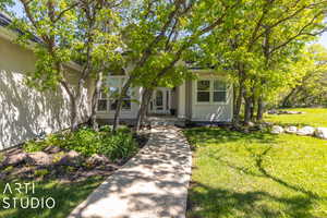 View of front entrance of property with a front lawn