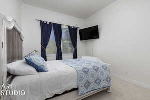 Bedroom featuring crown molding and carpet floors