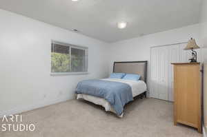 Carpeted bedroom with a closet