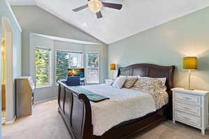 Master bedroom with vaulted ceiling and bay window.