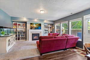 Inviting family room with large windows and a gas log fireplace.