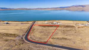 Birds eye view of property with a water and mountain view