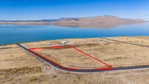 Birds eye view of property featuring a water and mountain view