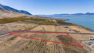 Birds eye view of property featuring a water and mountain view