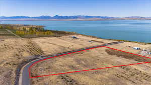 Birds eye view of property with a water and mountain view