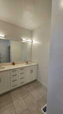 Bathroom featuring oversized vanity and double sink