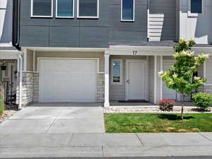 View of exterior entry with a garage