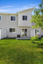 Back of house featuring a lawn, central AC unit, and a patio area