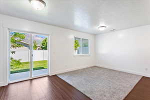 Great room with a wealth of natural light and dark hardwood / wood-style floors