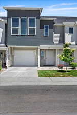 Townhome / multi-family property featuring a garage