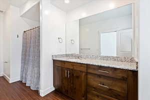 Bathroom with hardwood / wood-style floors and vanity