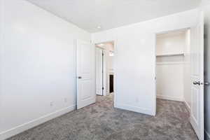 Unfurnished bedroom with carpet and a closet