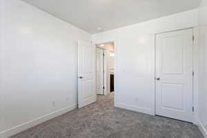 Unfurnished bedroom featuring carpet flooring