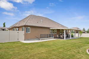 Back of house with a patio area and a yard