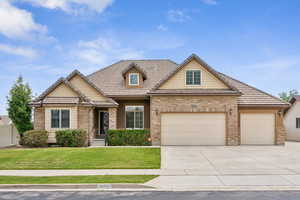 View of front of house featuring a garage and a front yard