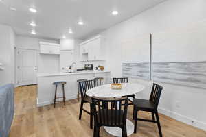 Dining space featuring sink and light hardwood / wood-style floors