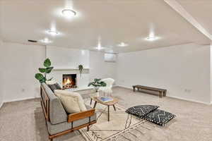 Living room with carpet flooring and a brick fireplace