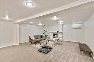 Sitting room with carpet, brick wall, and a brick fireplace