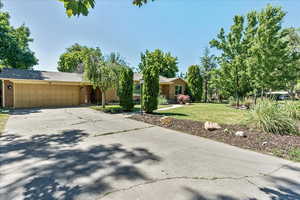 View of front of home with a front lawn and a garage