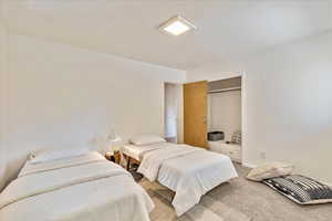 Carpeted bedroom featuring a closet