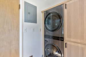 Washroom featuring stacked washer and clothes dryer