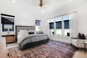 Carpeted bedroom featuring ceiling fan