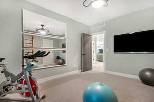 Exercise room with light colored carpet