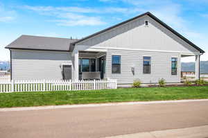 Exterior space with a front yard and a porch