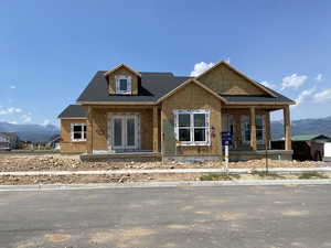 Property under construction featuring a mountain view and a porch