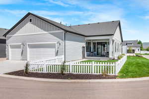 View of front facade with a garage and a porch