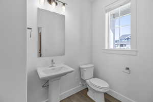 Bathroom with toilet and hardwood / wood-style floors