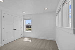 Unfurnished bedroom with carpet flooring and a closet