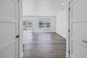 Unfurnished room with dark wood-type flooring