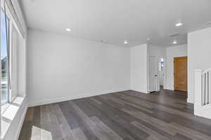 Unfurnished room with dark wood-type flooring