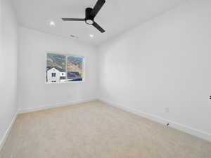 Carpeted empty room with ceiling fan