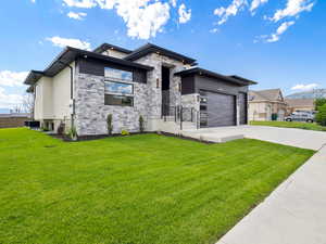 Prairie-style house featuring a garage and a front yard