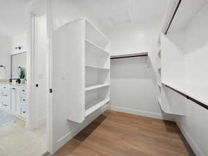 Walk in closet featuring light wood-type flooring