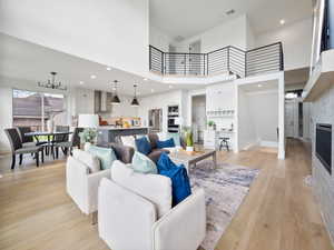 Living room featuring light hardwood / wood-style floors and a towering ceiling